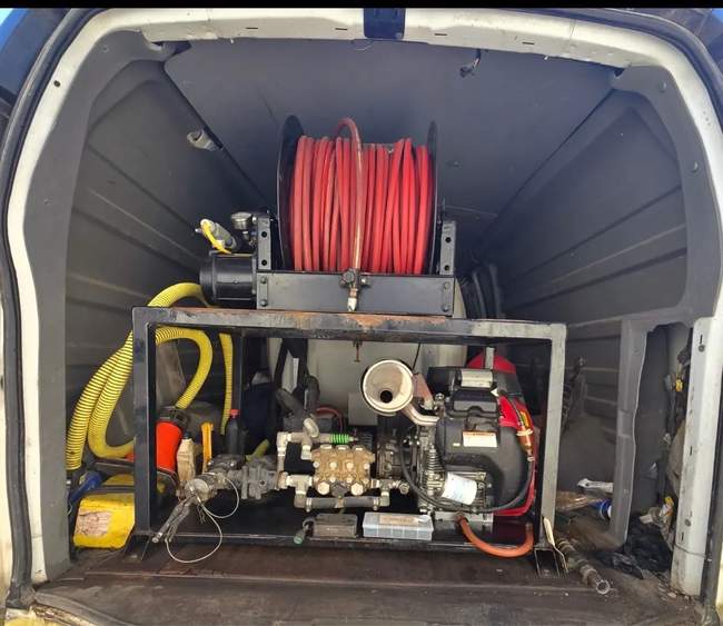Van-mounted drain jetter and hose reel