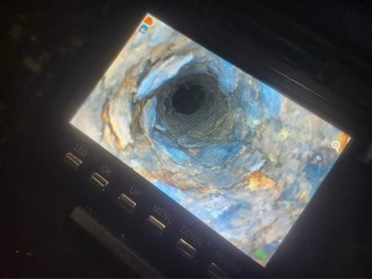 Sewer camera monitor showing the interior condition of a residential drain line