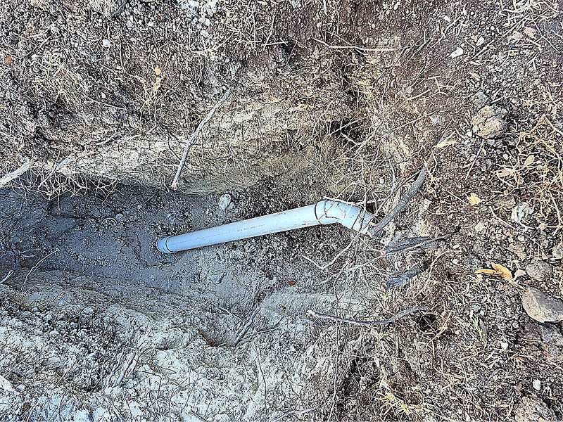 New white PVC sewer pipe installed in a trench by a San Antonio plumber