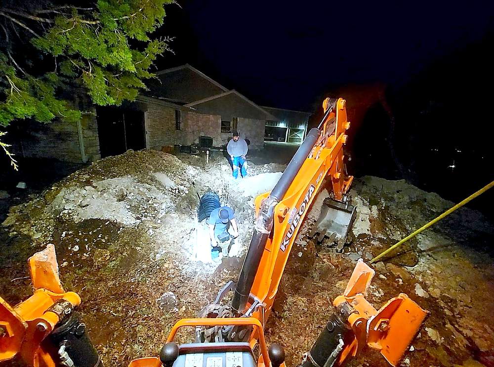 Zeus Plumbing crew working a night excavation for emergency sewer repair in San Antonio, Texas