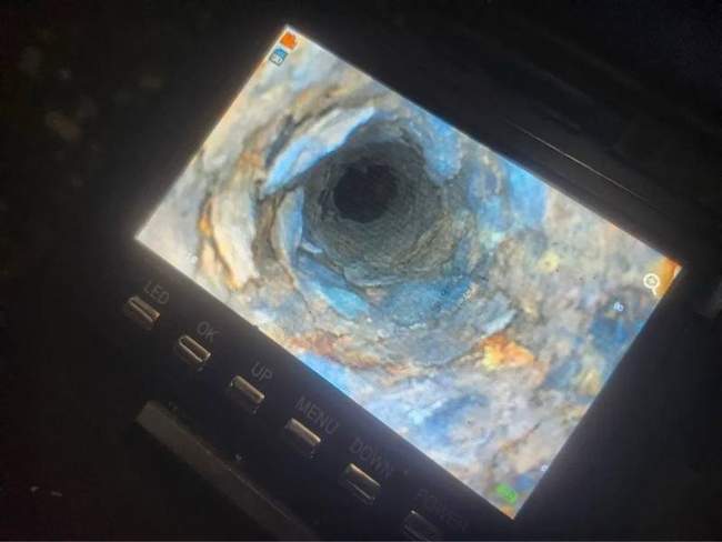 Sewer camera inspection monitor showing the inside of a pipe